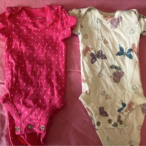 Two newborn Carter’s onesies.